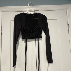 Long sleeve black crop top with ties at bottom!